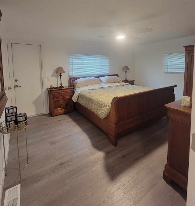 bedroom with ceiling fan and wood-type flooring