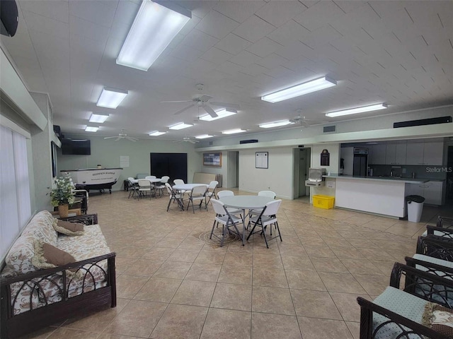 interior space with ceiling fan and light tile patterned floors