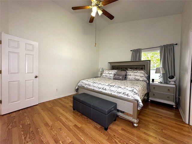 bedroom featuring ceiling fan, wood-type flooring, and lofted ceiling