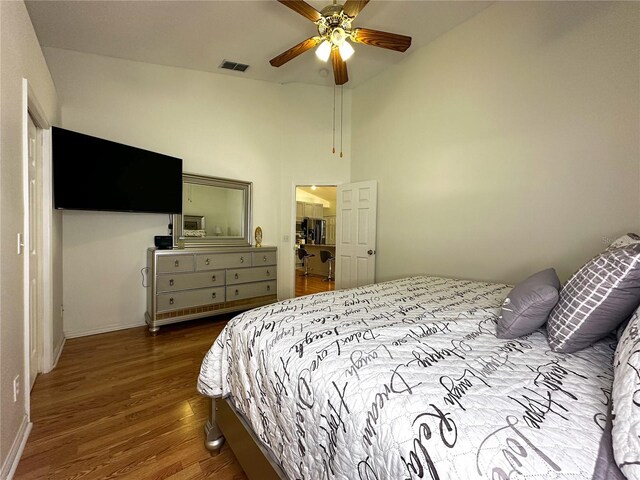 bedroom with ceiling fan and dark hardwood / wood-style flooring