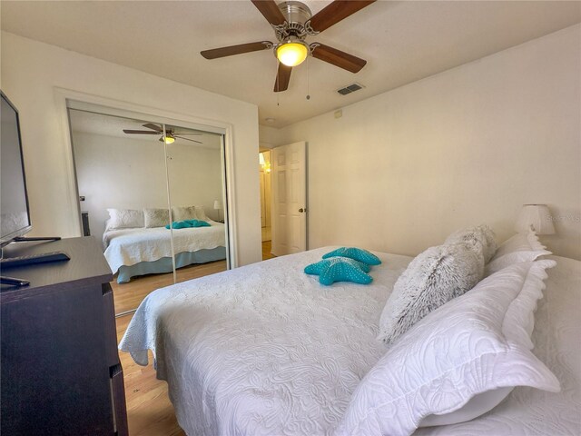 bedroom featuring a closet, hardwood / wood-style floors, and ceiling fan