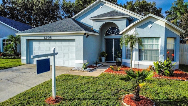 ranch-style house with a garage and a front lawn