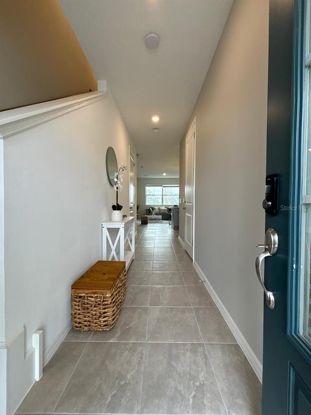 hall with light tile patterned flooring