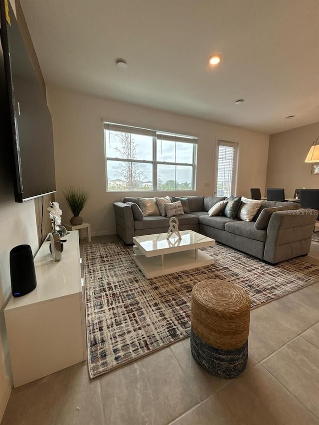 living room featuring plenty of natural light and light tile patterned floors