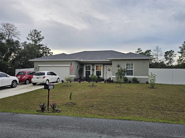 view of front of property featuring a garage and a front lawn