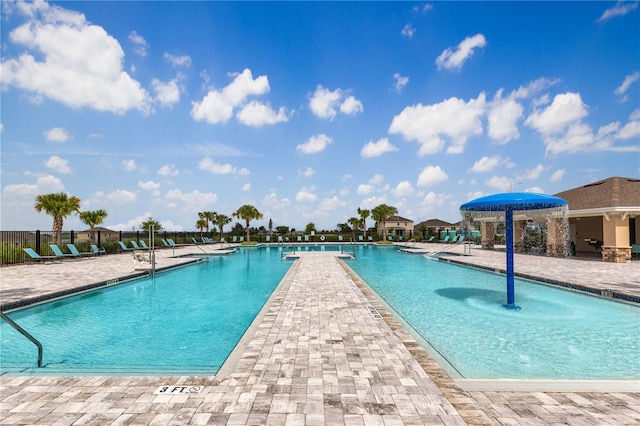 view of pool featuring pool water feature and a patio