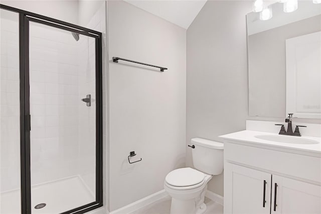 bathroom featuring vanity, a shower with shower door, and toilet