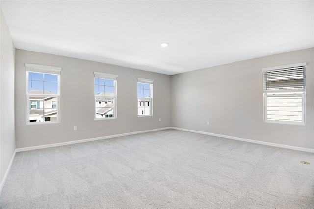 spare room featuring light colored carpet