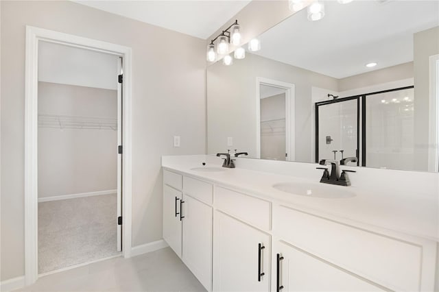 bathroom with tile patterned flooring, vanity, and walk in shower