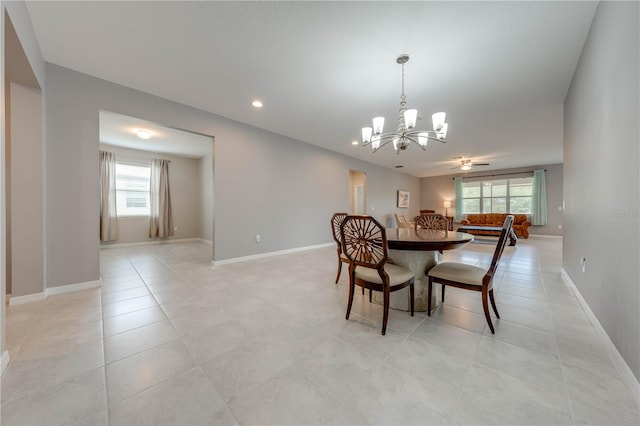 tiled dining area featuring a notable chandelier and a healthy amount of sunlight