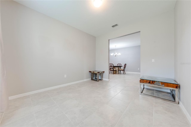 unfurnished room featuring light tile patterned floors and a chandelier