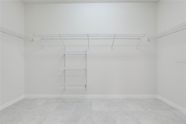 spacious closet featuring tile patterned flooring