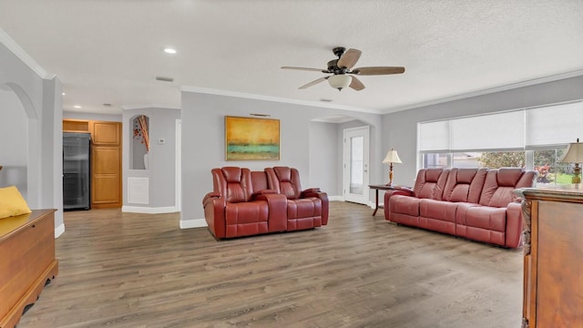 living room with ceiling fan, ornamental molding, and hardwood / wood-style flooring