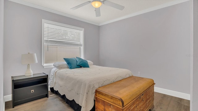 bedroom featuring crown molding, ceiling fan, and hardwood / wood-style floors