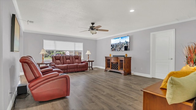 living room featuring ceiling fan, wood-type flooring, and ornamental molding