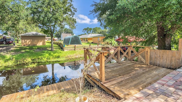 exterior space featuring a storage shed and a water view