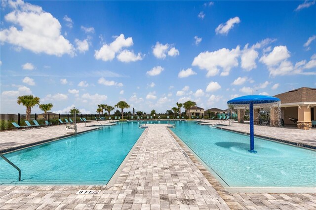 view of swimming pool with a patio and pool water feature