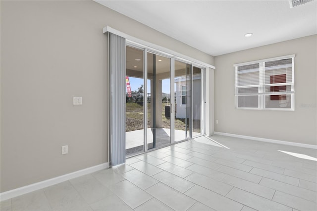 unfurnished room featuring light tile patterned flooring