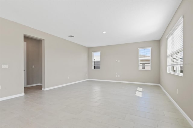 spare room featuring light tile patterned floors