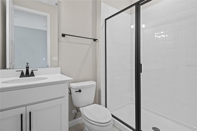 bathroom with vanity, toilet, and walk in shower