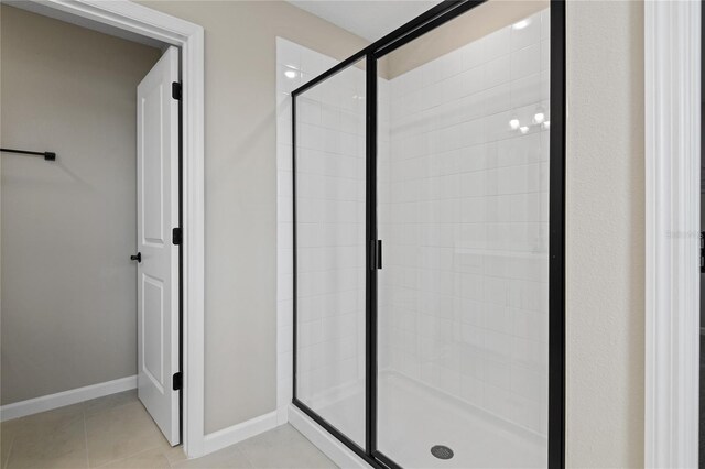 bathroom with tile patterned flooring and an enclosed shower