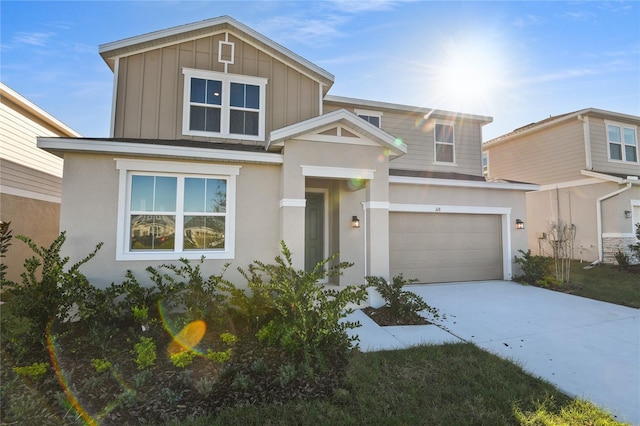 view of front of property featuring driveway, board and batten siding, an attached garage, and stucco siding