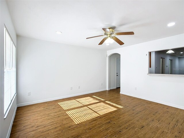 empty room with hardwood / wood-style floors and ceiling fan