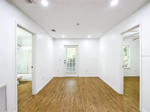 spare room featuring wood-type flooring and ceiling fan