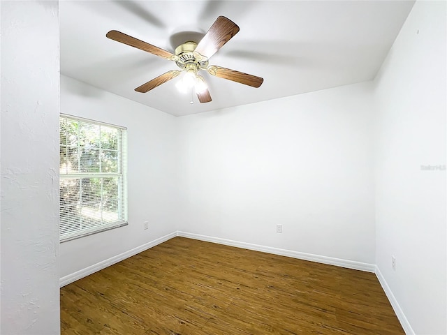 empty room with ceiling fan and dark hardwood / wood-style floors