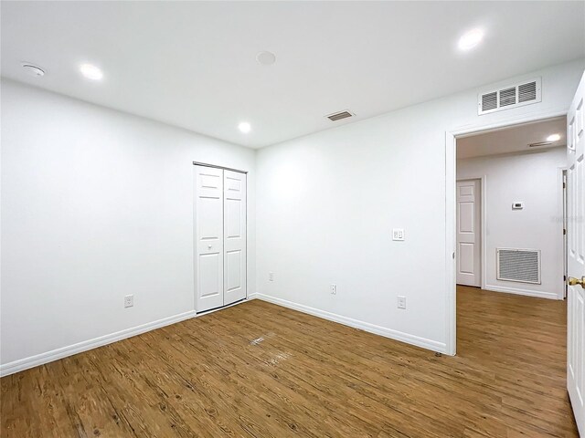 unfurnished room with hardwood / wood-style flooring