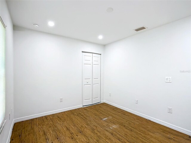 spare room with hardwood / wood-style flooring