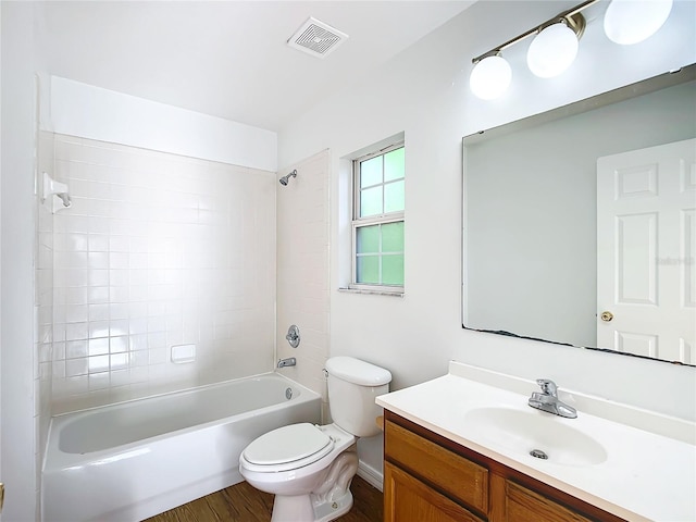 full bathroom featuring tiled shower / bath, vanity, toilet, and wood-type flooring