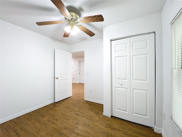 unfurnished bedroom featuring ceiling fan, a closet, and wood-type flooring