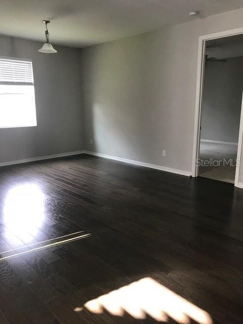 unfurnished room featuring dark hardwood / wood-style floors