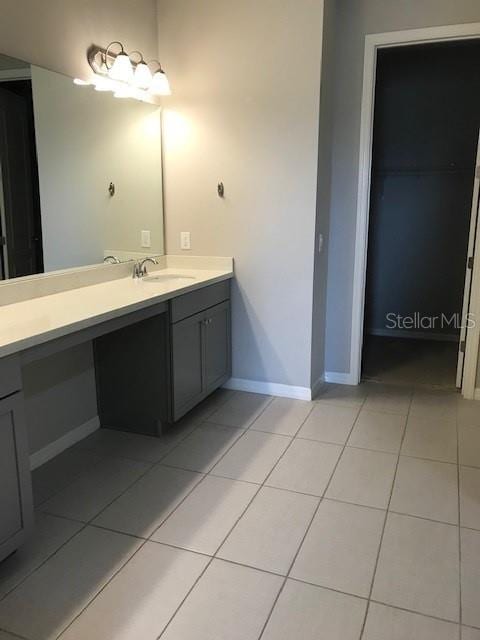 full bath with tile patterned floors, vanity, and baseboards