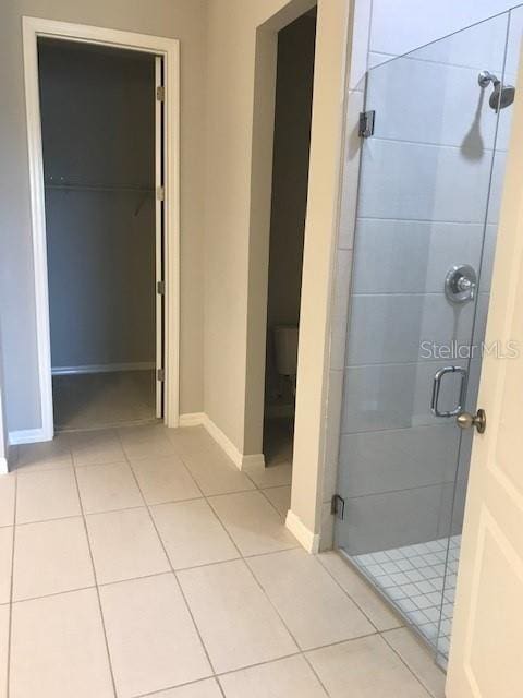 bathroom featuring tile patterned flooring and a shower with door