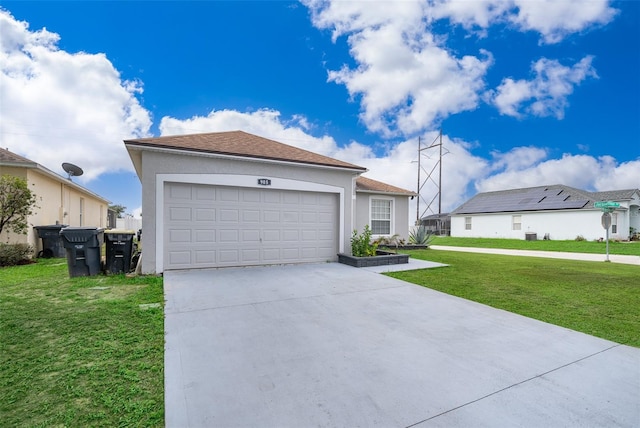 view of front of home with a garage and a front lawn