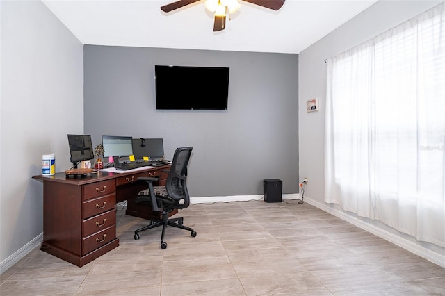 office with a healthy amount of sunlight and ceiling fan