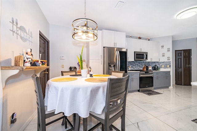 dining space featuring a notable chandelier