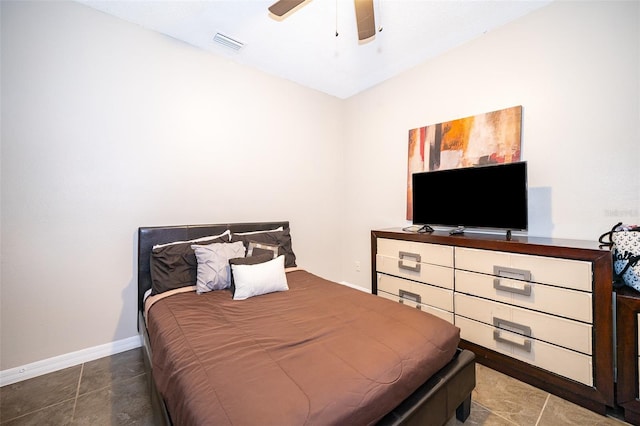 tiled bedroom featuring ceiling fan