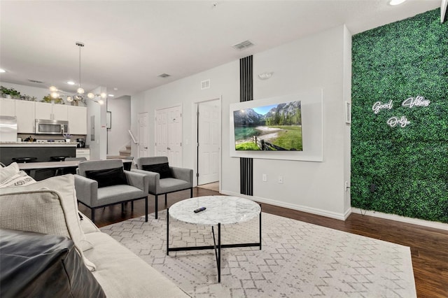 8968 Silver Pl, Kissimmee, FL 34747 - living room with wood finished floors, a chandelier, recessed lighting, stairs, and baseboards