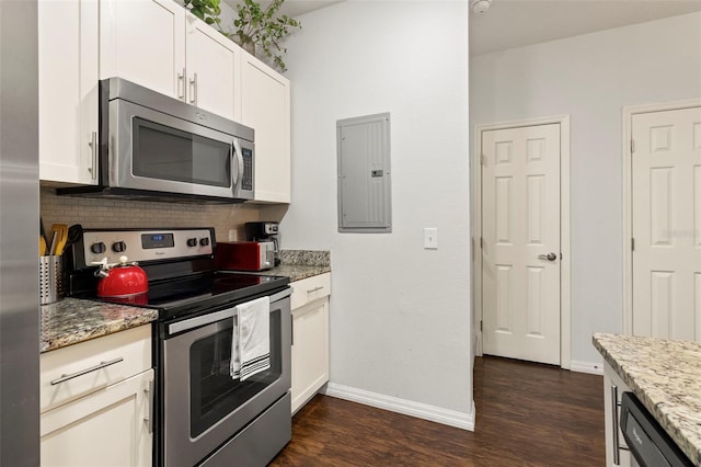 kitchen with light stone countertops, stainless steel appliances, dark hardwood / wood-style flooring, and white cabinetry