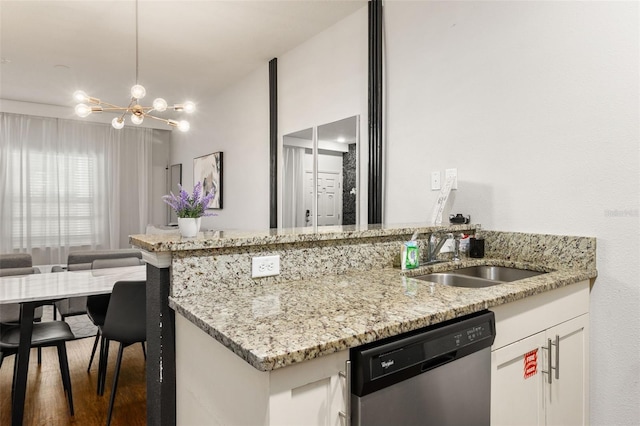 kitchen with white cabinetry, dark hardwood / wood-style flooring, light stone counters, sink, and stainless steel dishwasher