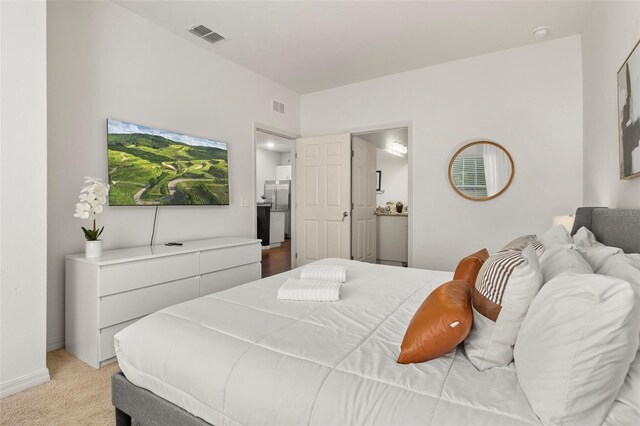 8968 Silver Pl, Kissimmee, FL 34747 - bedroom with freestanding refrigerator, light carpet, and baseboards