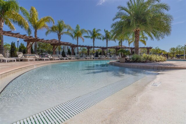 8968 Silver Pl, Kissimmee, FL 34747 - community pool featuring a pergola, fence, and a patio area