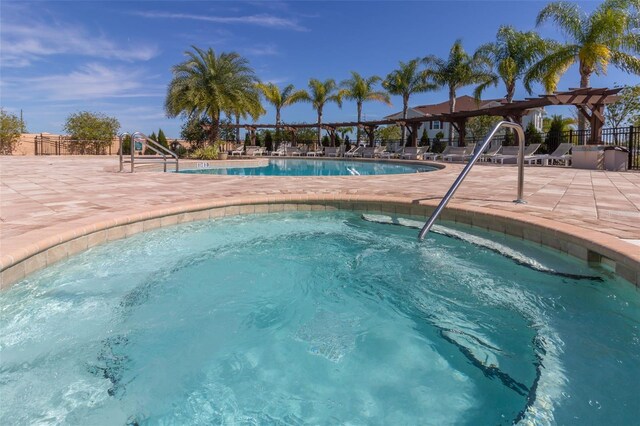 8968 Silver Pl, Kissimmee, FL 34747 - community pool featuring a patio, fence, and a community hot tub
