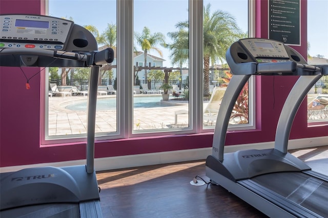 exercise room with dark wood-type flooring