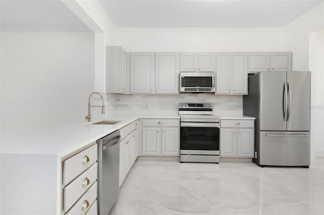 kitchen featuring appliances with stainless steel finishes, tasteful backsplash, and sink