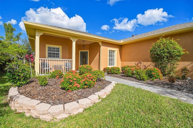 single story home with a porch and a front yard