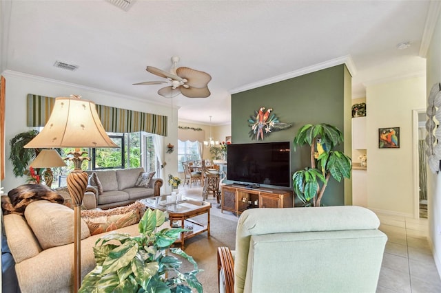 living room with ornamental molding, ceiling fan with notable chandelier, and tile patterned floors